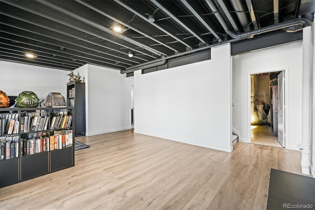 basement with light hardwood / wood-style flooring