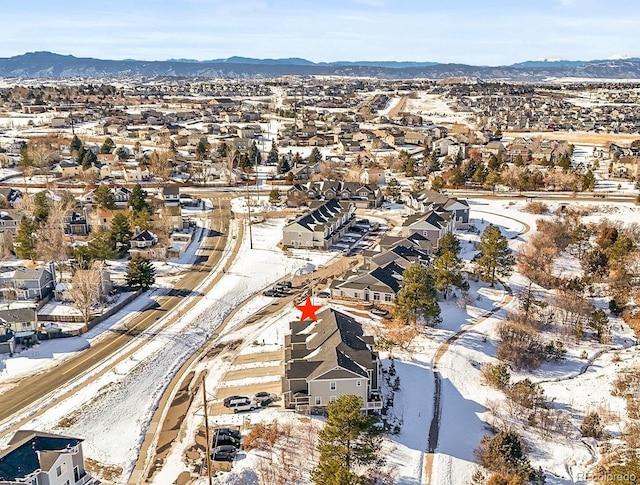 snowy aerial view with a mountain view