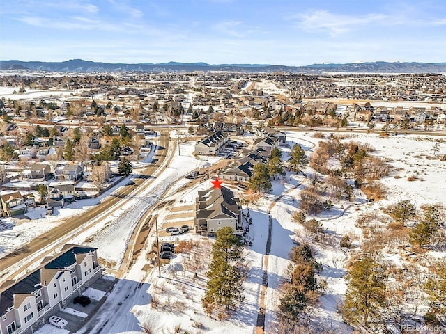 snowy aerial view with a mountain view