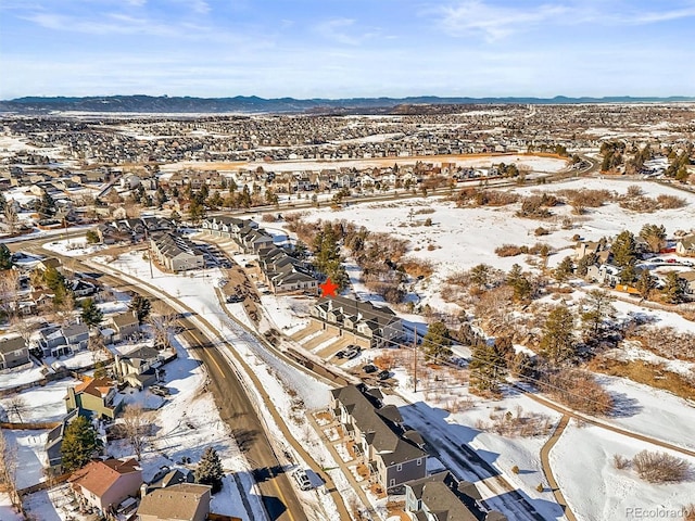 snowy aerial view with a mountain view