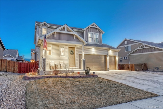 view of front of property with board and batten siding, covered porch, fence, and an attached garage