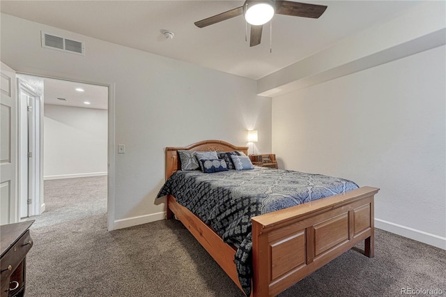 bedroom with visible vents, dark carpet, baseboards, and ceiling fan