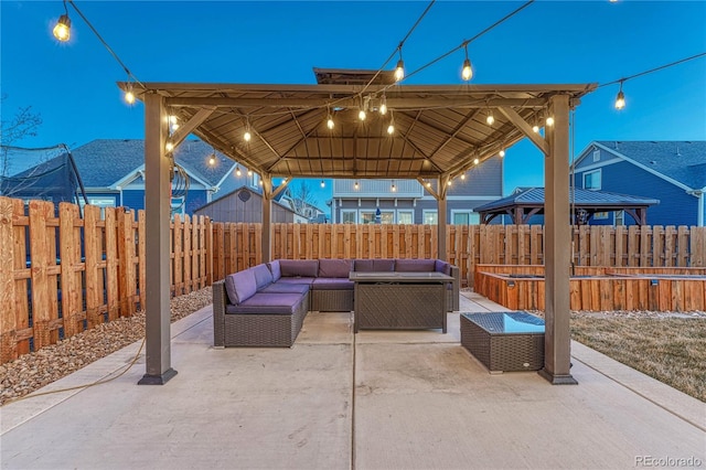 view of patio / terrace with a fenced backyard, an outdoor living space, and a gazebo