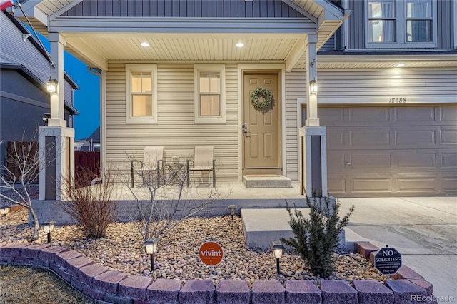 property entrance featuring board and batten siding and a garage