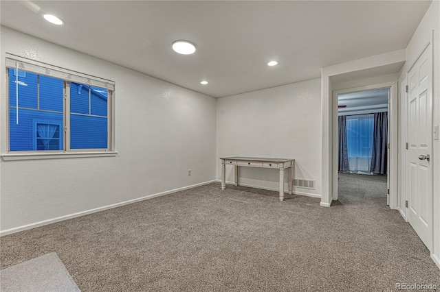 carpeted spare room featuring recessed lighting, visible vents, and baseboards