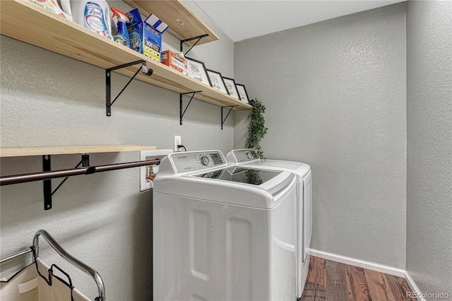 laundry room with laundry area, baseboards, washer and clothes dryer, a textured wall, and dark wood-style flooring