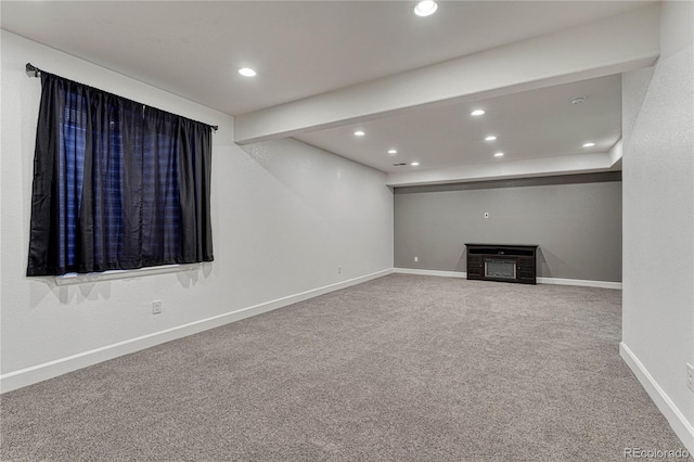 unfurnished living room with recessed lighting, carpet flooring, a fireplace, and baseboards