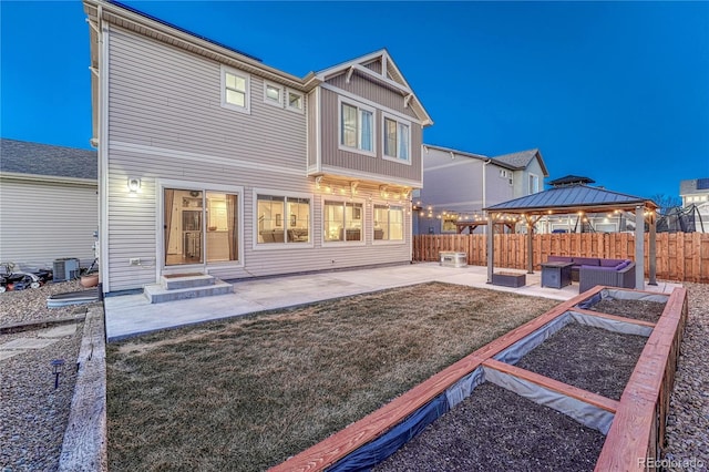 back of property featuring outdoor lounge area, a patio, a gazebo, and fence