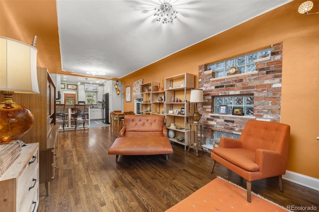 2514 N Humboldt St, Denver, CO 80205 - sitting room with wood finished floors, baseboards, and a brick fireplace