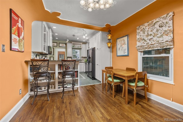 2514 N Humboldt St, Denver, CO 80205 - dining room featuring dark wood-style floors, baseboards, and a chandelier