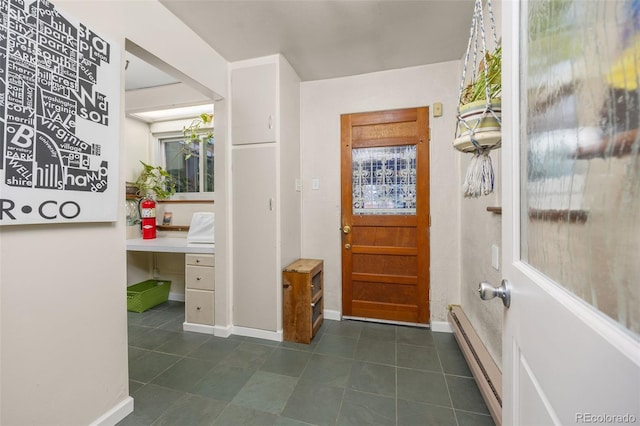 2514 N Humboldt St, Denver, CO 80205 - entrance foyer with baseboard heating, dark tile patterned flooring, and baseboards