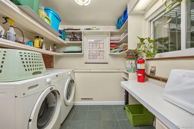 2514 N Humboldt St, Denver, CO 80205 - washroom with washer and dryer, dark tile patterned floors, and baseboards