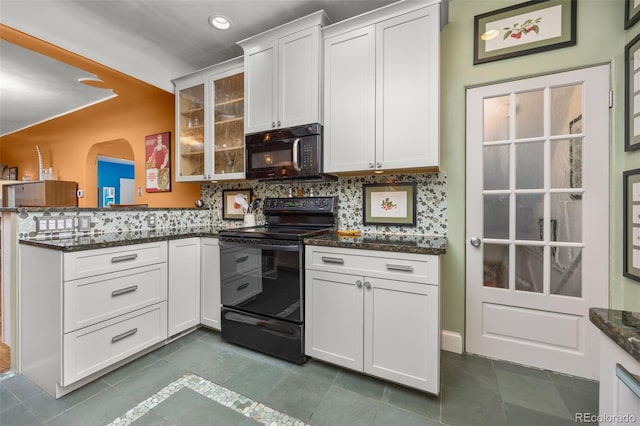 2514 N Humboldt St, Denver, CO 80205 - kitchen featuring black appliances, white cabinetry, a peninsula, dark stone counters, and glass insert cabinets