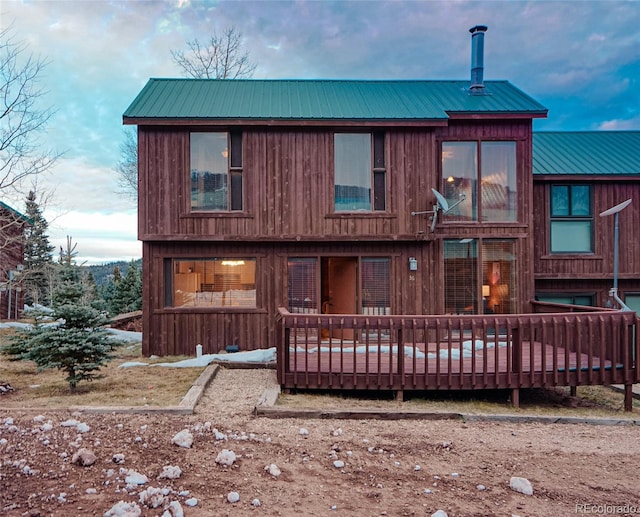 back of house featuring a deck