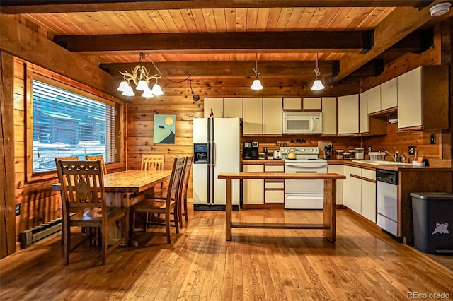 kitchen with white appliances, a notable chandelier, light hardwood / wood-style floors, white cabinetry, and hanging light fixtures