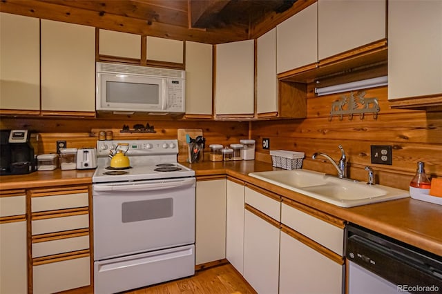 kitchen featuring white cabinets, white appliances, and sink