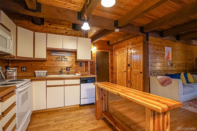 kitchen featuring wood walls, white appliances, white cabinets, light wood-type flooring, and beam ceiling