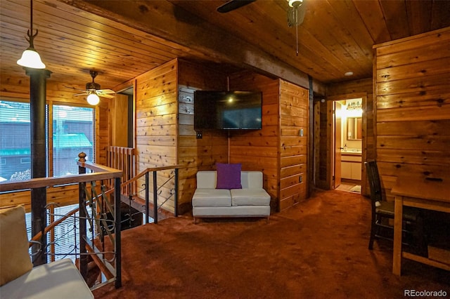 interior space with carpet flooring, wood walls, and wood ceiling