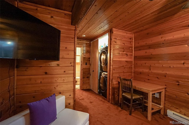 interior space with stacked washing maching and dryer, baseboard heating, wooden walls, and wood ceiling