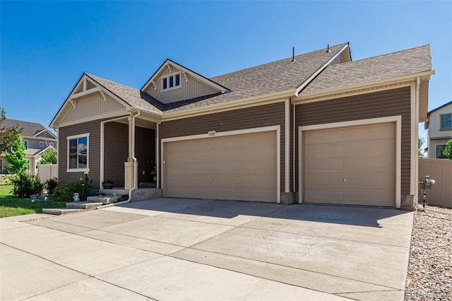 5568 Ceylon St, Denver, CO 80249 - view of front of house with an attached garage, driveway, and roof with shingles