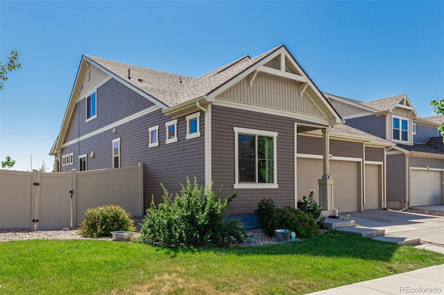 5568 Ceylon St, Denver, CO 80249 - view of property exterior with concrete driveway, a garage, a gate, board and batten siding, and a shingled roof