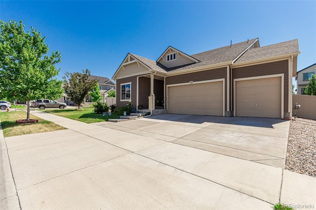 5568 Ceylon St, Denver, CO 80249 - view of front facade with an attached garage, concrete driveway, and roof with shingles