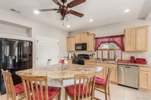 5568 Ceylon St, Denver, CO 80249 - kitchen with black appliances, light brown cabinetry, a kitchen breakfast bar, light tile patterned floors, and ceiling fan