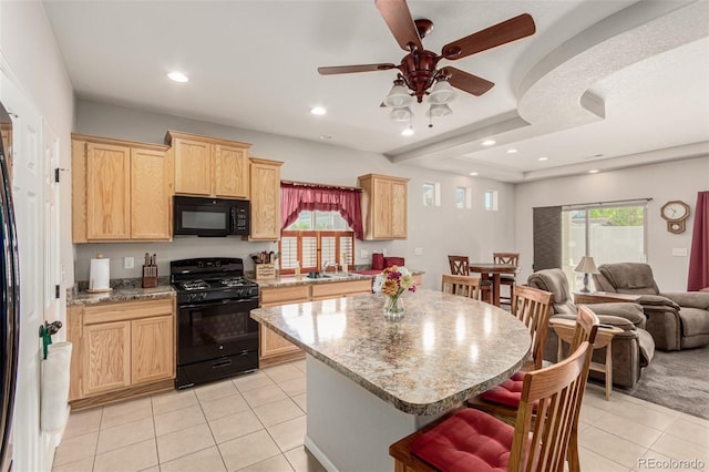 5568 Ceylon St, Denver, CO 80249 - kitchen featuring black appliances, light brown cabinets, light tile patterned flooring, a kitchen breakfast bar, and open floor plan