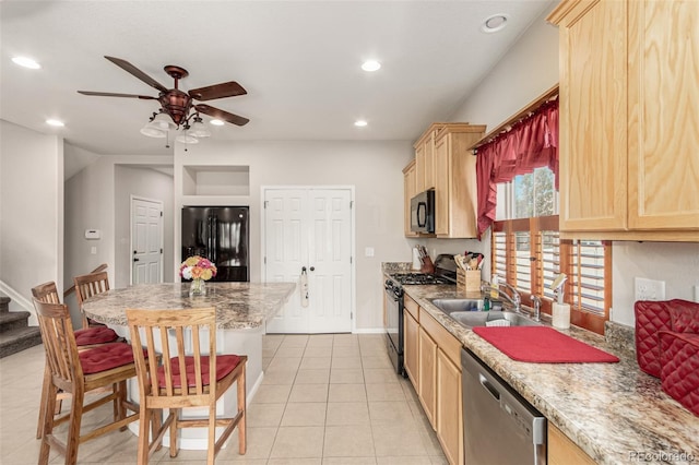 5568 Ceylon St, Denver, CO 80249 - kitchen with black appliances, light brown cabinets, a ceiling fan, recessed lighting, and a breakfast bar area