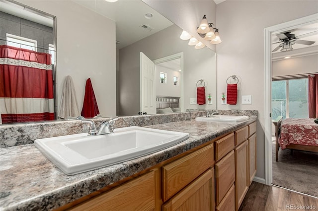 5568 Ceylon St, Denver, CO 80249 - ensuite bathroom with double vanity, wood finished floors, and ceiling fan