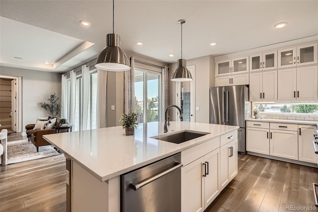 4955 N Picadilly Ct, Aurora, CO 80019 - kitchen featuring appliances with stainless steel finishes, a sink, hardwood / wood-style flooring, white cabinetry, and recessed lighting