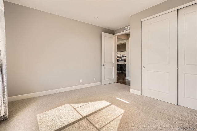 4955 N Picadilly Ct, Aurora, CO 80019 - unfurnished bedroom featuring light colored carpet, baseboards, and a closet