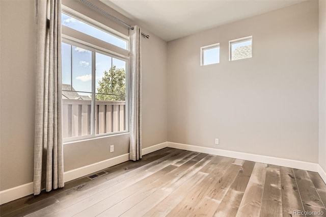 4955 N Picadilly Ct, Aurora, CO 80019 - empty room with hardwood / wood-style flooring and baseboards