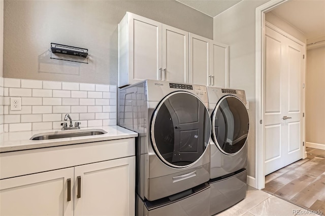 4955 N Picadilly Ct, Aurora, CO 80019 - washroom with separate washer and dryer, cabinet space, and baseboards