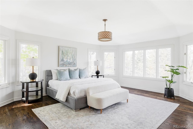 bedroom featuring baseboards and dark wood-style floors