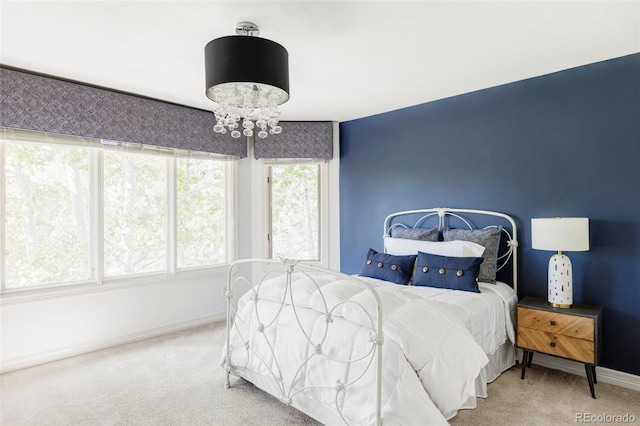 bedroom featuring baseboards and carpet