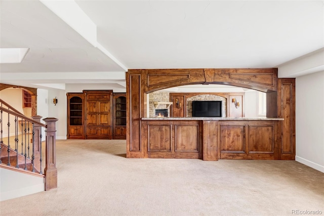 carpeted living room with stairs and baseboards