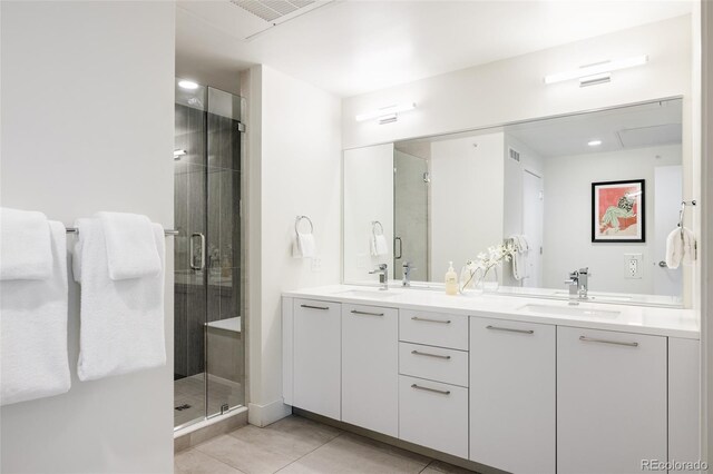 bathroom featuring tile patterned flooring, vanity, and an enclosed shower