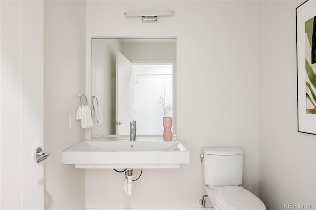 bathroom with toilet and sink