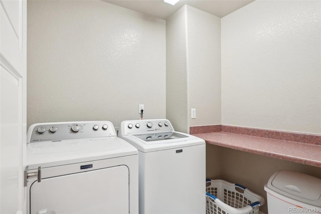 clothes washing area featuring washing machine and clothes dryer