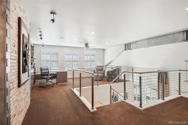 hallway with brick wall and dark colored carpet