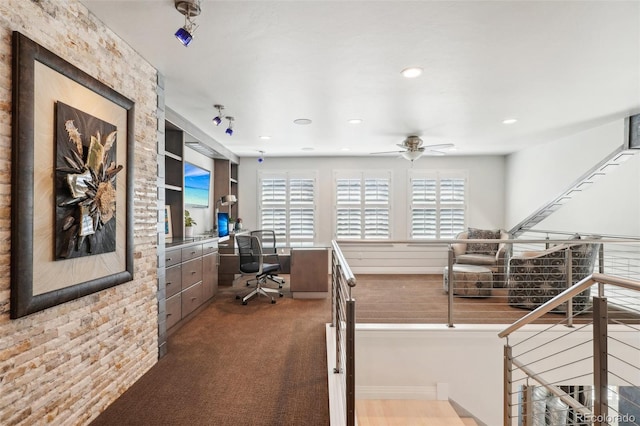 carpeted home office with ceiling fan