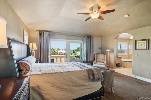 carpeted bedroom with ceiling fan, ensuite bath, and access to outside