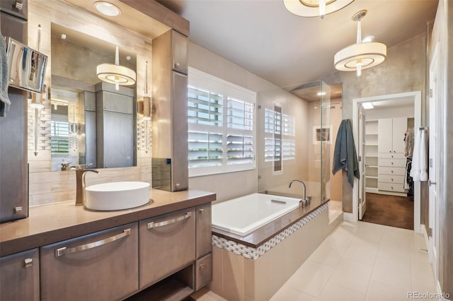 bathroom with vanity and separate shower and tub