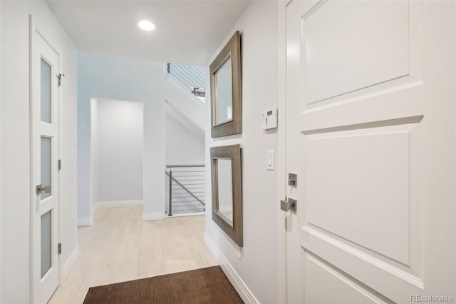 foyer entrance with light hardwood / wood-style floors