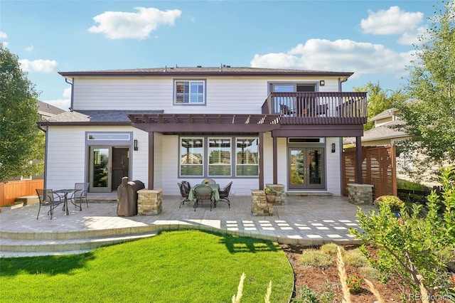 back of house with a pergola, a patio area, and a lawn