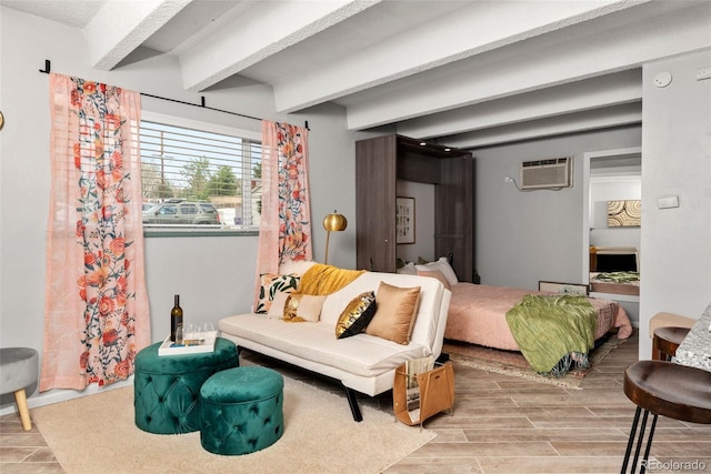 bedroom with a wall mounted air conditioner and wood-type flooring