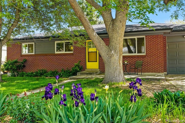 6088 Quail Ct, Arvada, CO 80004 - view of front of house with brick siding, an attached garage, and entry steps