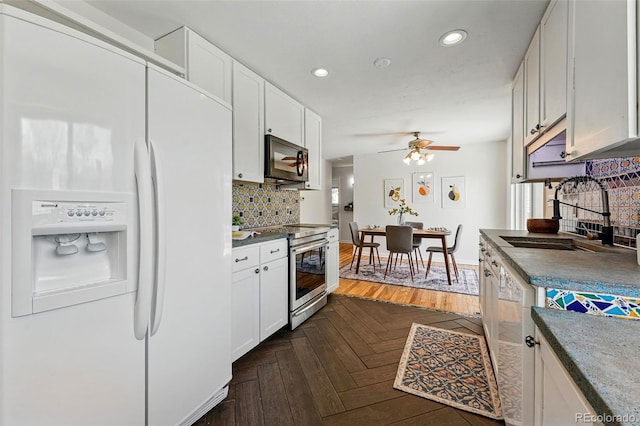 6088 Quail Ct, Arvada, CO 80004 - kitchen with white fridge with ice dispenser, stainless steel electric stove, a sink, black microwave, and a ceiling fan