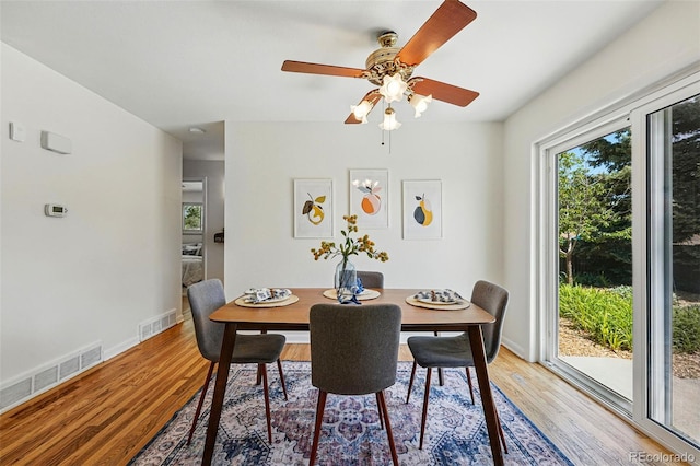 6088 Quail Ct, Arvada, CO 80004 - dining area featuring plenty of natural light, wood finished floors, a ceiling fan, and baseboards